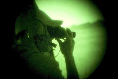 6/23/04- YUMA- A Border patrol Borstar agent is seen through night vision goggles while patroling the U.S./Mexico border in a Customs Black Hawk helicopter.  (Pat Shannahan/ The Arizona Republic)