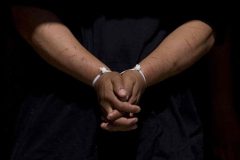 6/3/08- A illigal immigrant walk with his hands in plastic cuffs after being taken into custody by Maricopa County Sheriff's deputies at a drop house in west Phoenix. (Pat Shannahan/ The Arizona Republic)