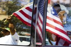 DIGITAL -- 5/1/06 -- A passenger looks out the window of a truck as he passes Alberto Tapia, left, of Glendale, Monday afternoon at a protest outside the Home Depot on McDowell Road in west Phoenix.  (Pat Shannahan/ The Arizona Republic)