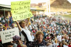 immig-buycott 164563 --- Sherry Kayser, (CQ) of Victorville, CA, holds a sign while attending Saturday's Buycott rally at Tempe Diablo Stadium. She said that her family planed on spending their entire vacation money in Arizona.  (Pat Shannahan/ The Arizona Republic)