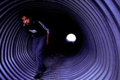 7/30/04- A migrant walks out of a drainage tube after being caught by the U.S. Border Patrol. He was hiding in the tube with several other migrants after the van they used to cross the border illegally broke down outside of Deming, New Mexico. (Pat Shannahan/ The Arizona Republic)