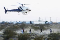 6/6/05-  A Border Patrol helicopter hovers above a group of undocumented immigrants June 6, 2005. The helicopter directed agents on foot to their location.  (Pat Shannahan/ The Arizona Republic)